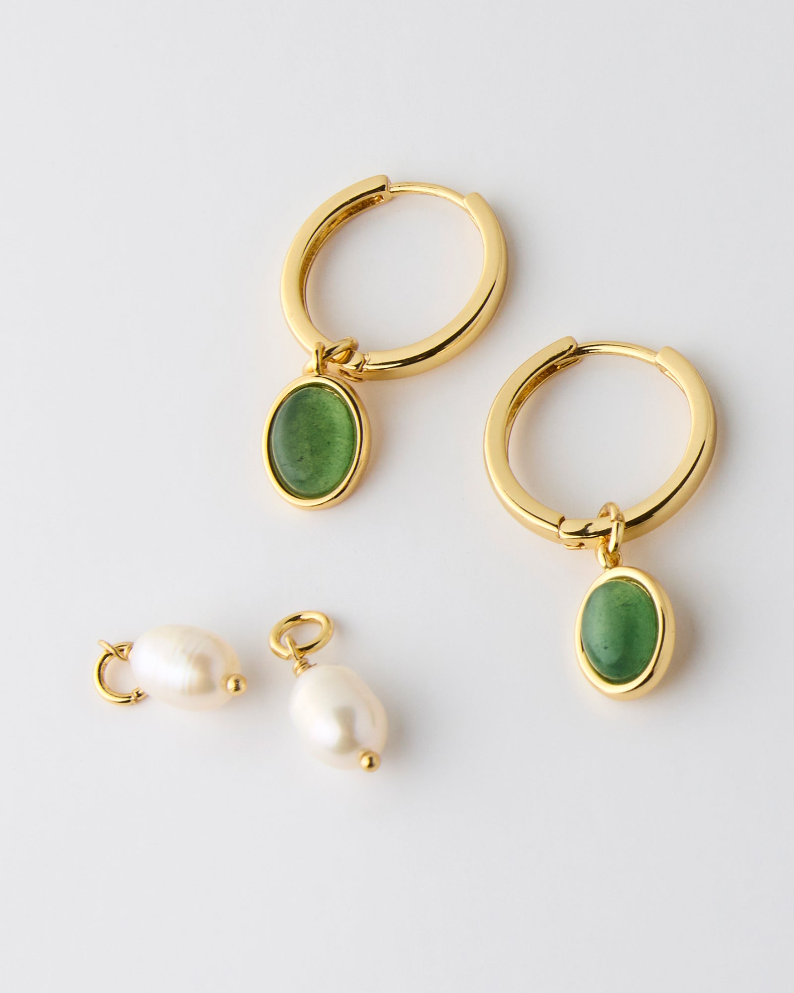 Gold hoops with interchangeable pendants of green stone or pearl