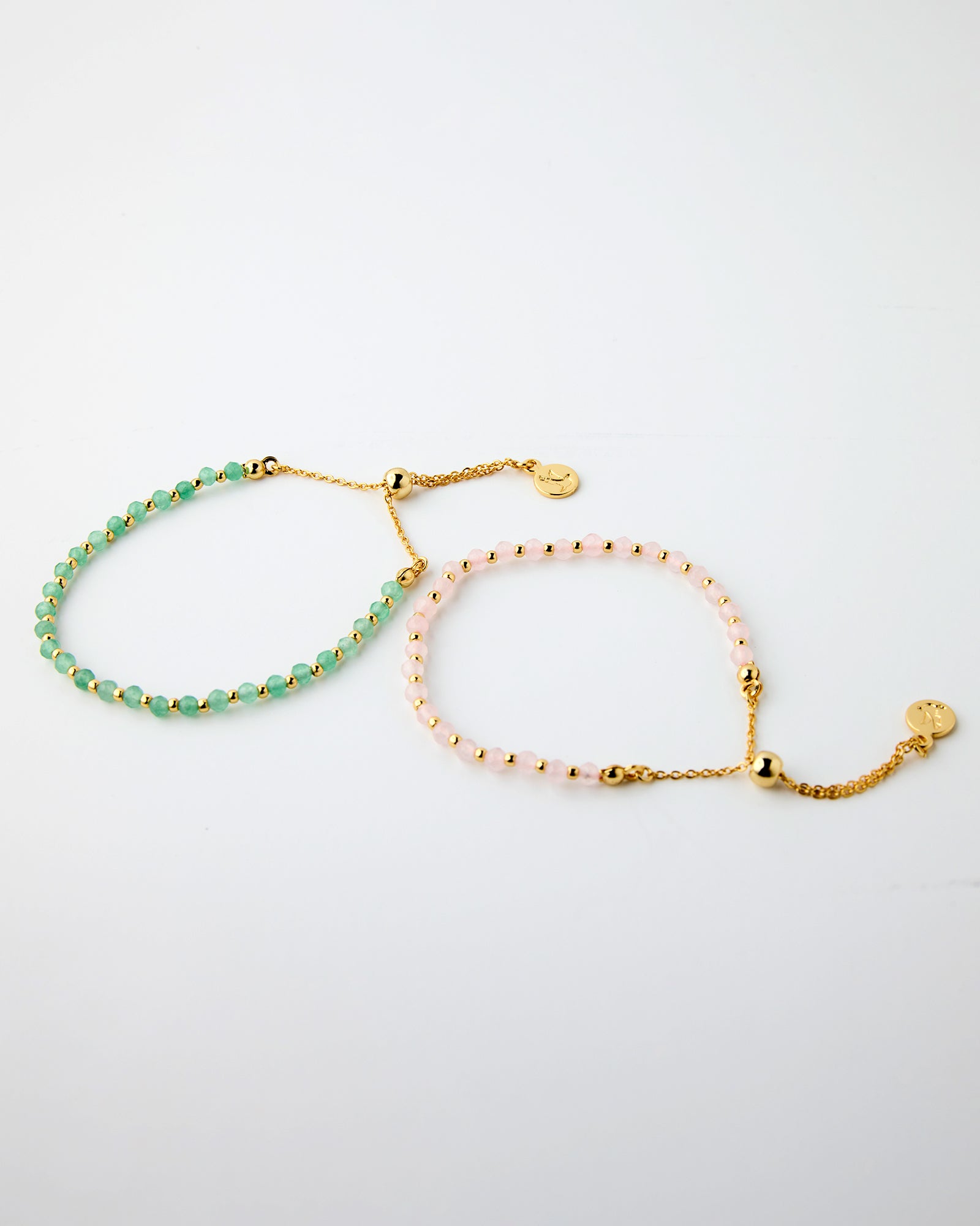 Set of two bracelets with gold chains and pink or green beads