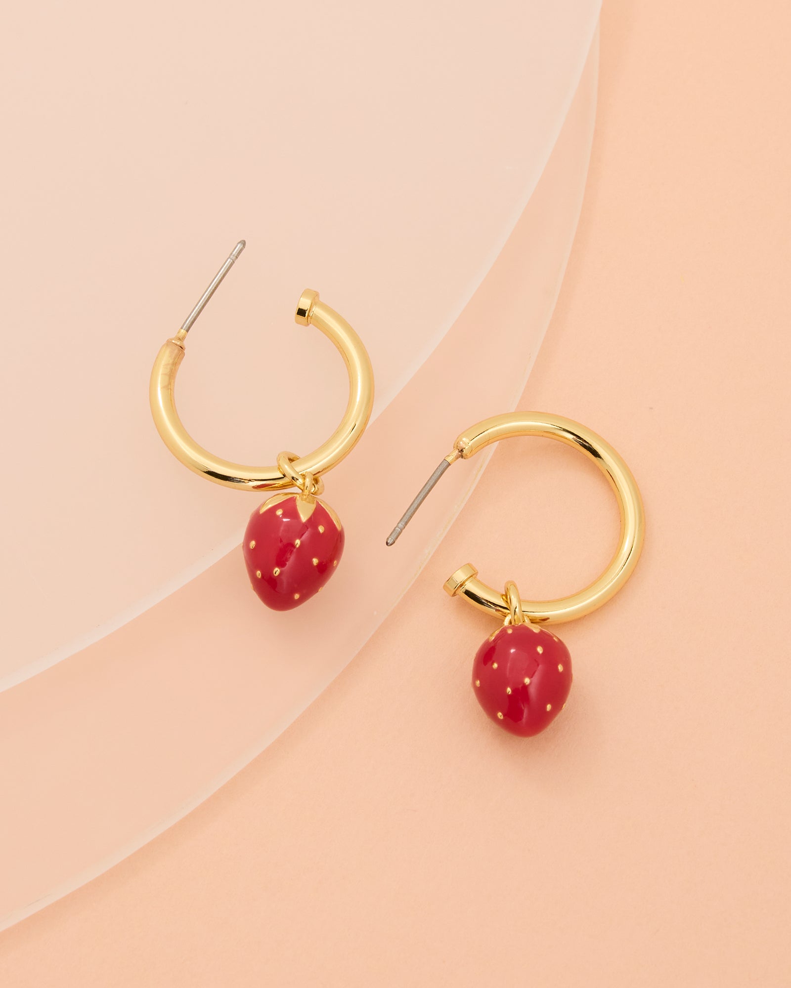 Gold hoop earrings with strawberry charm