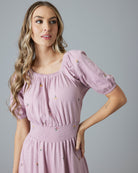 Woman in a purple, short sleeve, midi-dress