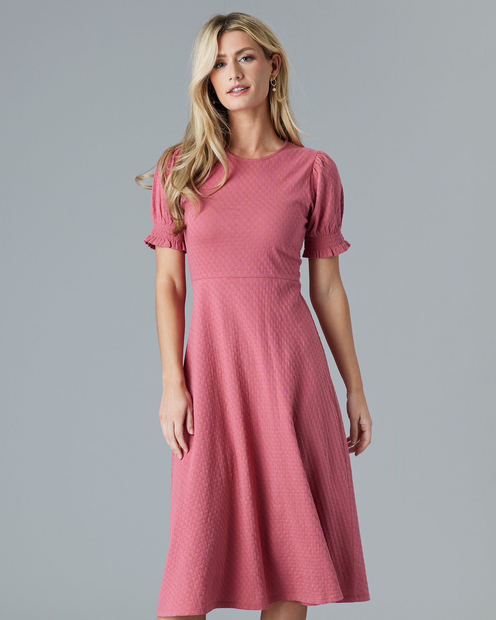 Woman in a pink short sleeve, midi-dress
