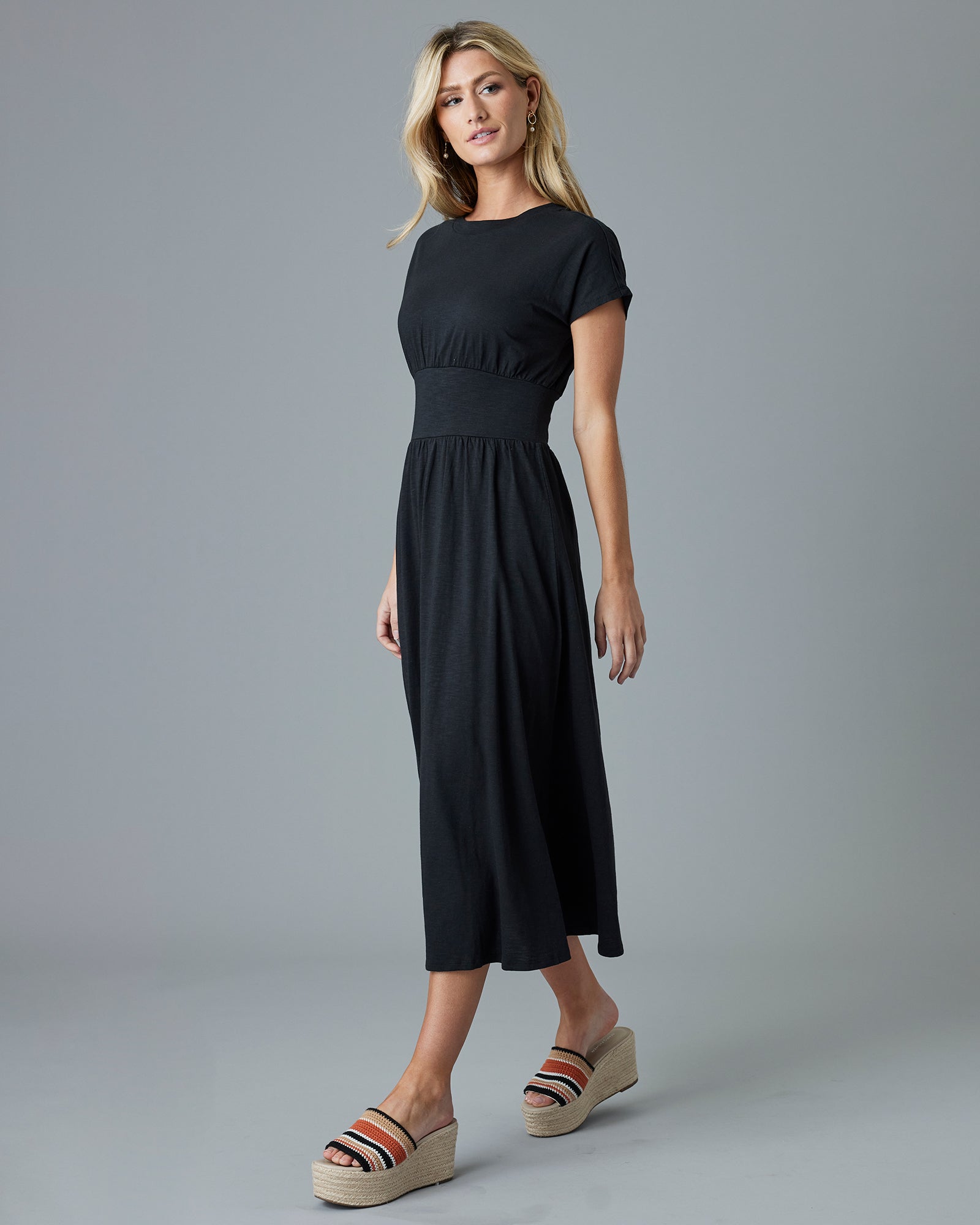 Woman in a black, short sleeve, midi dress
