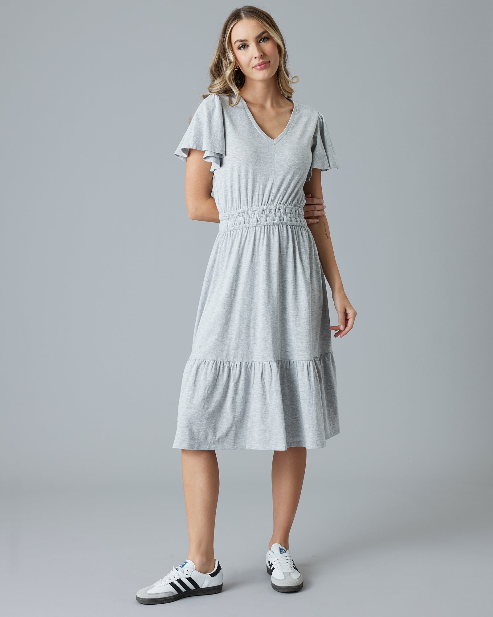 Woman in a grey short sleeve midi dress