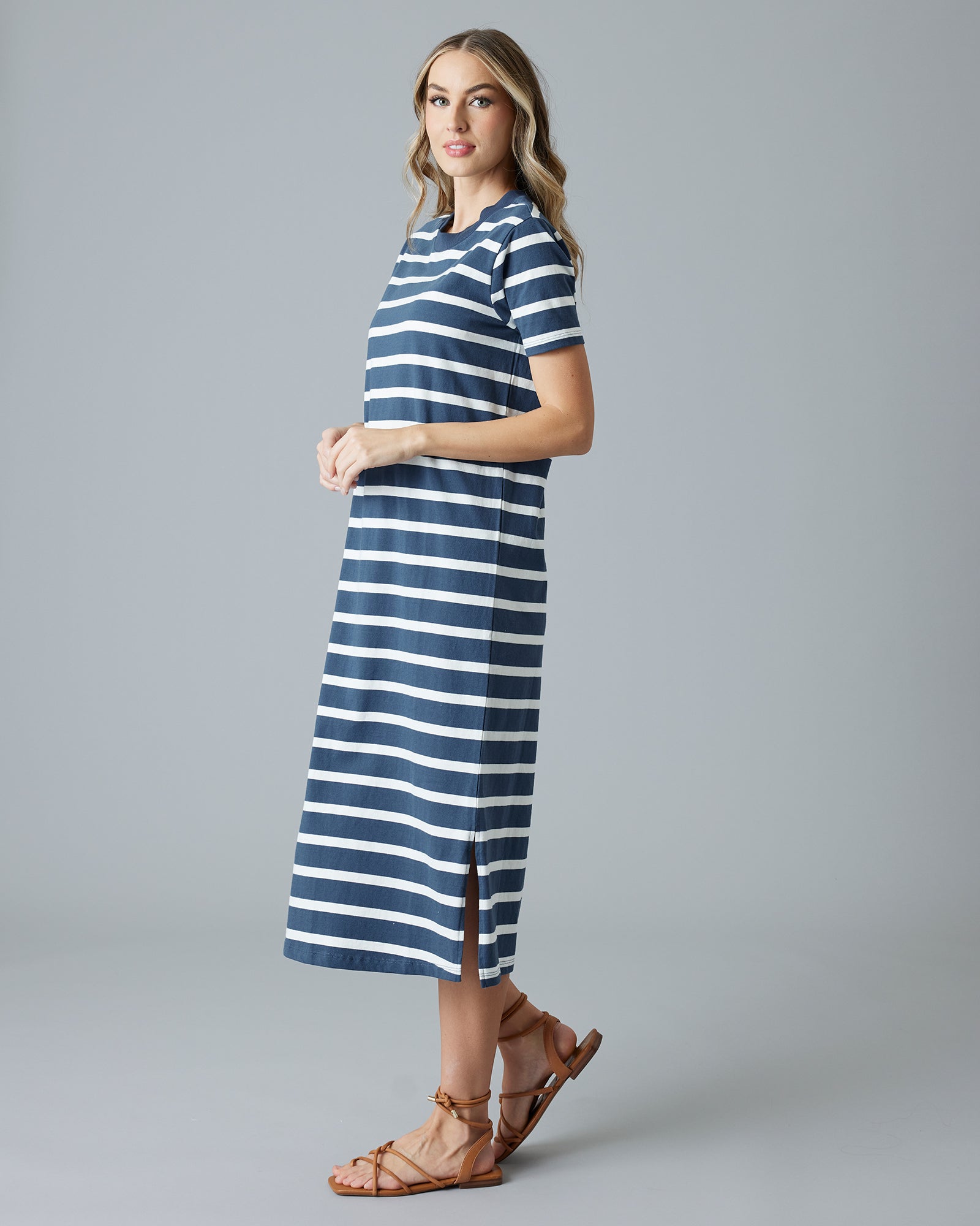 Woman in a navy and white striped short sleeve sheath dress