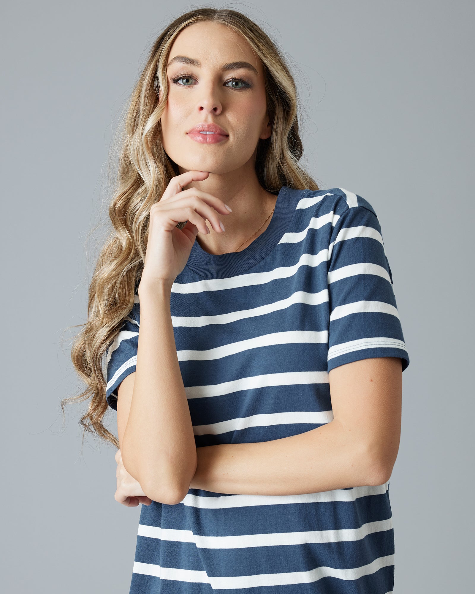 Woman in a navy and white striped short sleeve sheath dress
