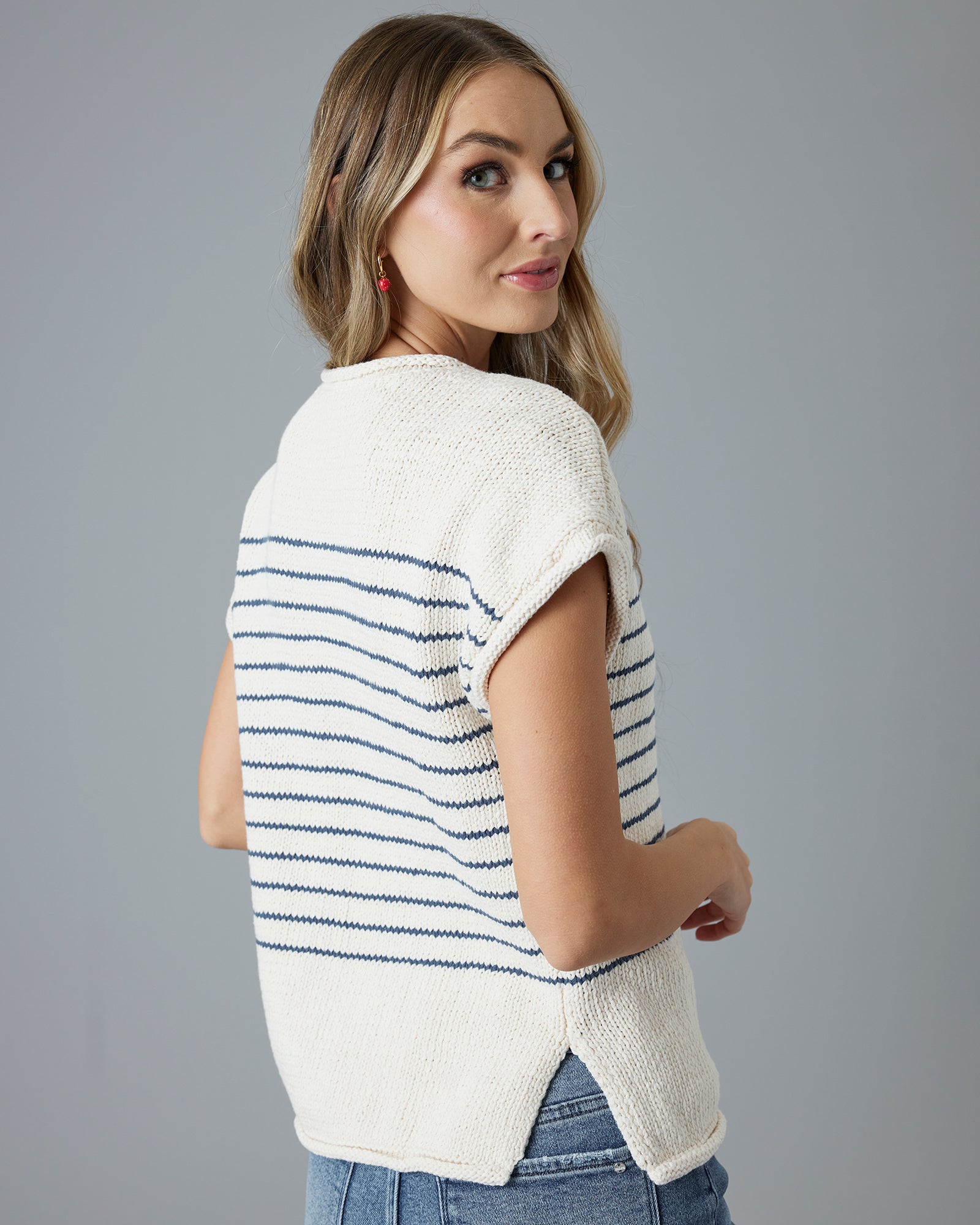 Woman in a cream with navy striped short sleeve sweater