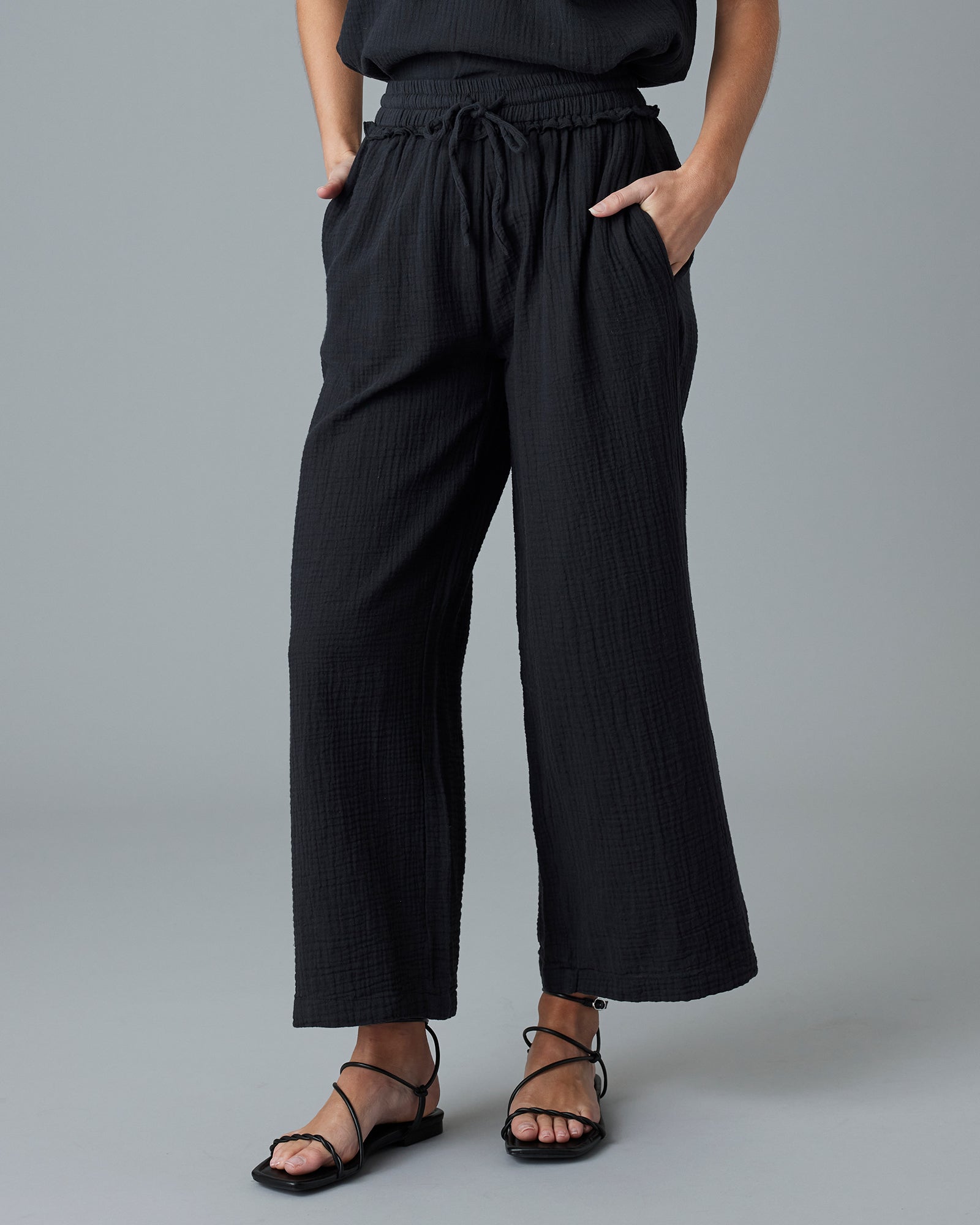 Woman in black ankle-length pants