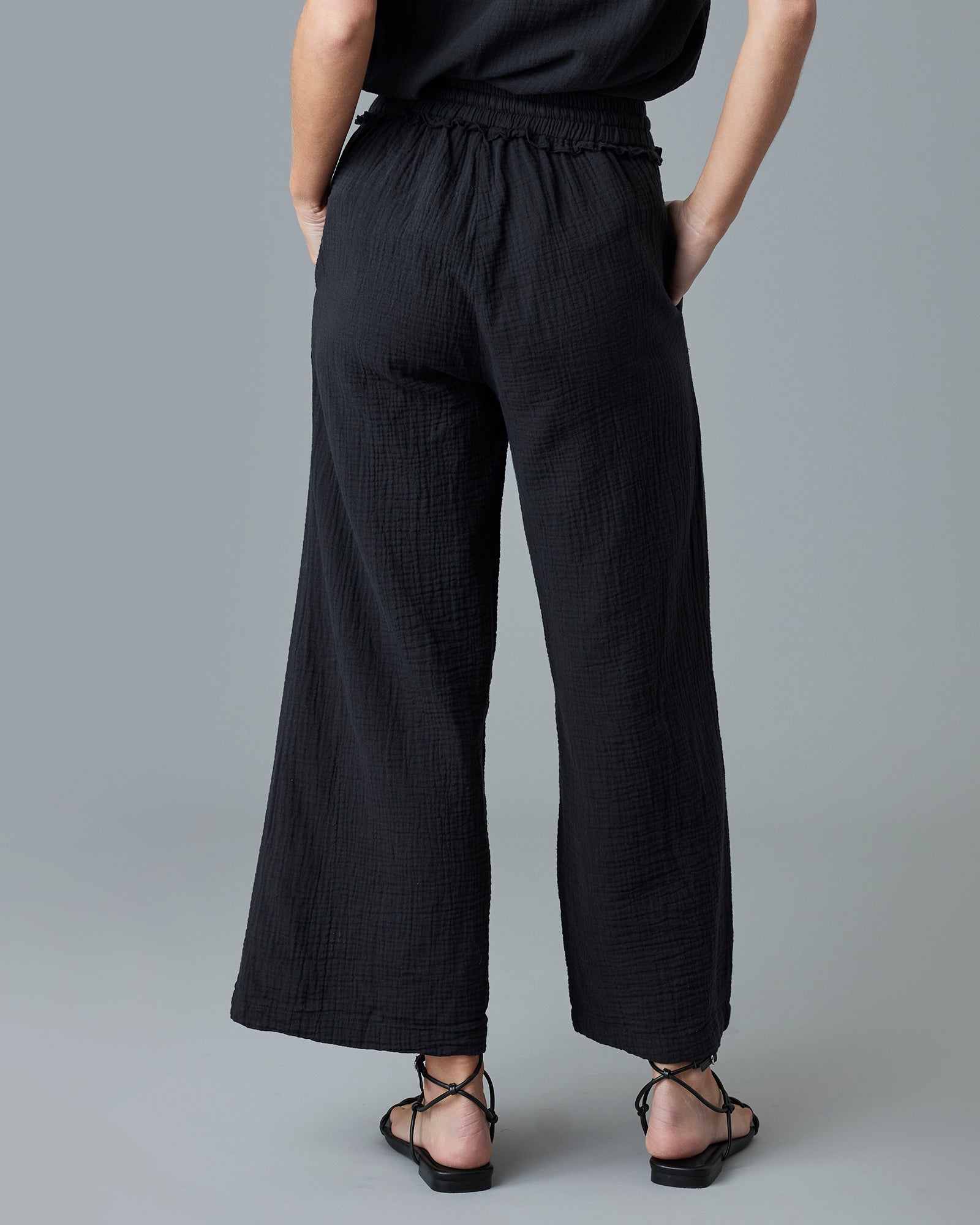 Woman in black ankle-length pants