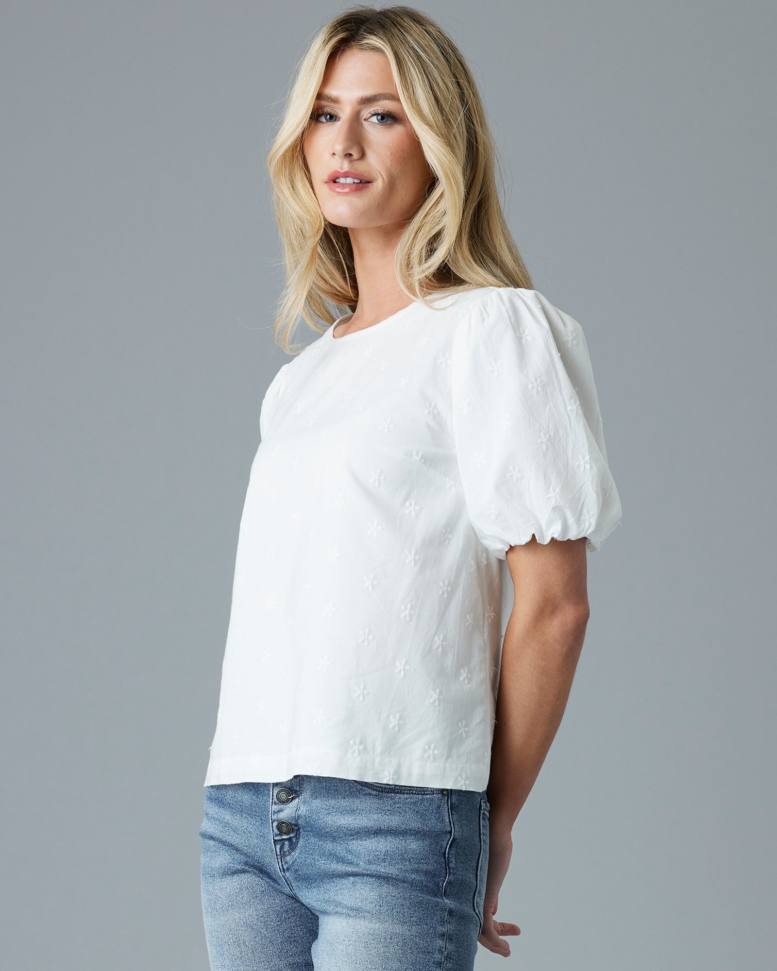 Woman in a white, short puffed sleeve blouse