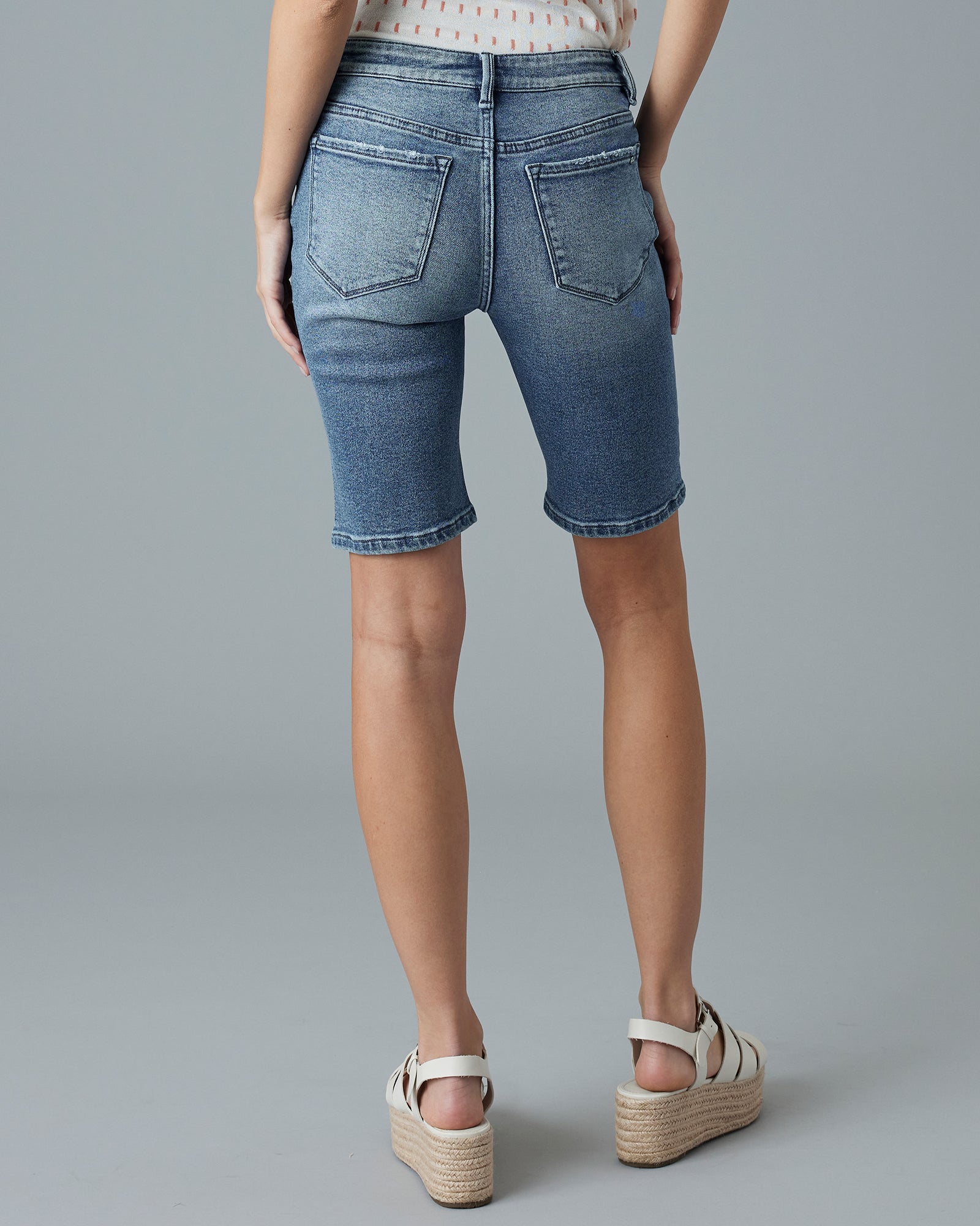 Woman in blue jean, button-fly shorts