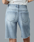Woman in light blue jean, straight bermuda shorts
