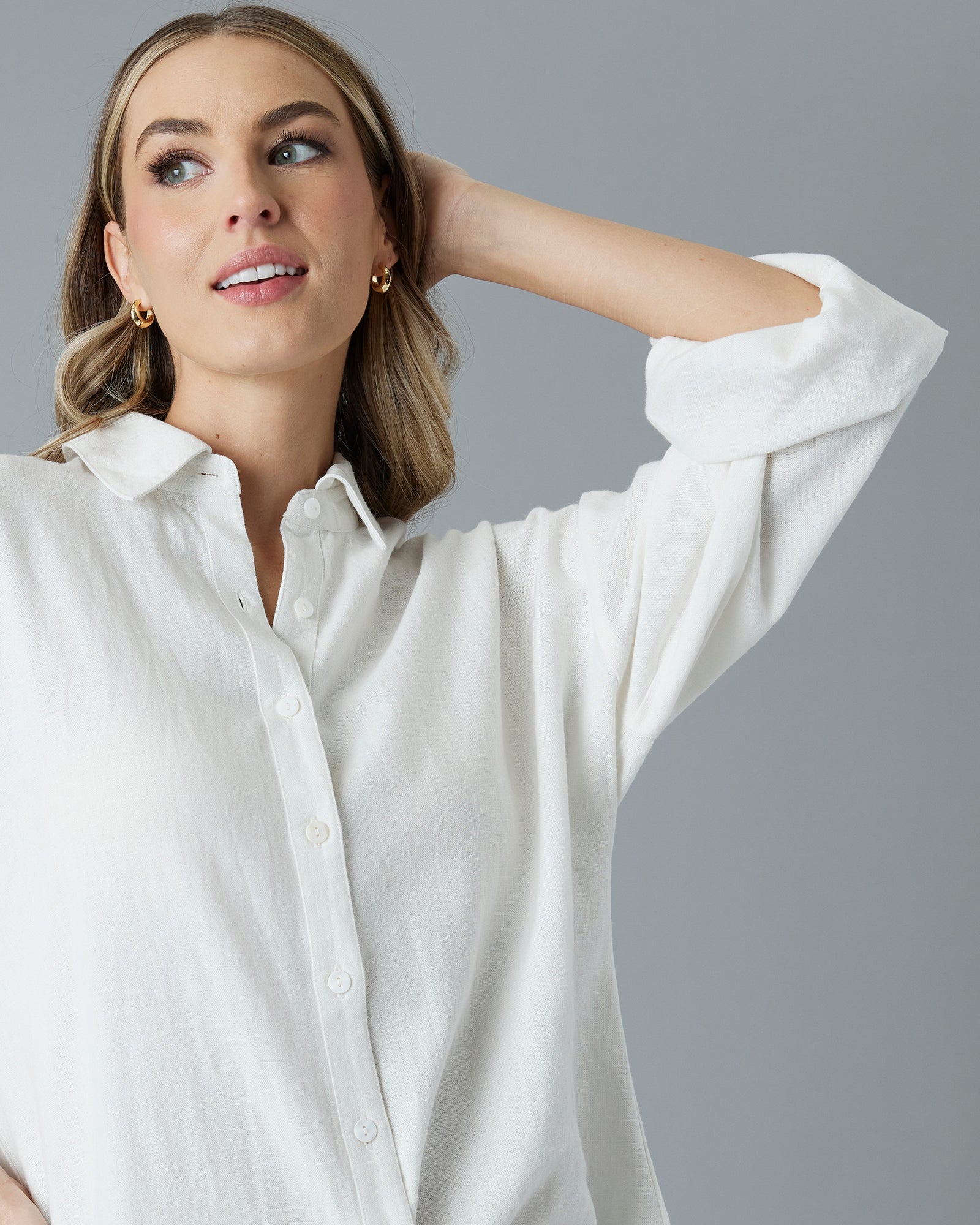 Woman in a white, over-sized, long sleeve buttondown