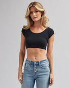 Woman in black, cropped short sleeve basic tee