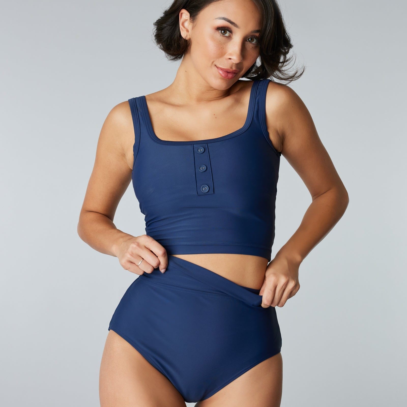 Woman in a two-piece swimsuit with a solid blue top and bottom.