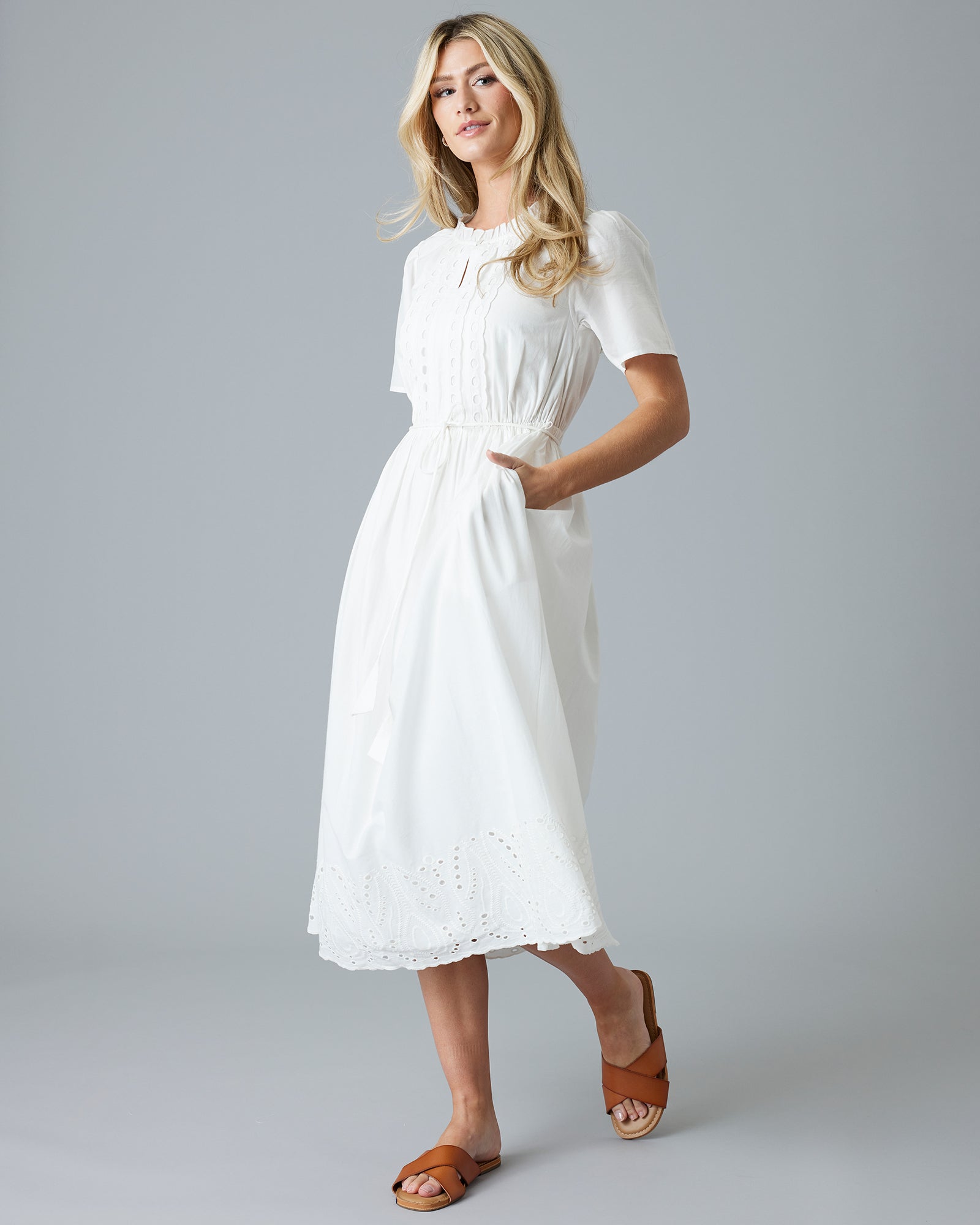 Woman in a white short sleeve midi-length dress