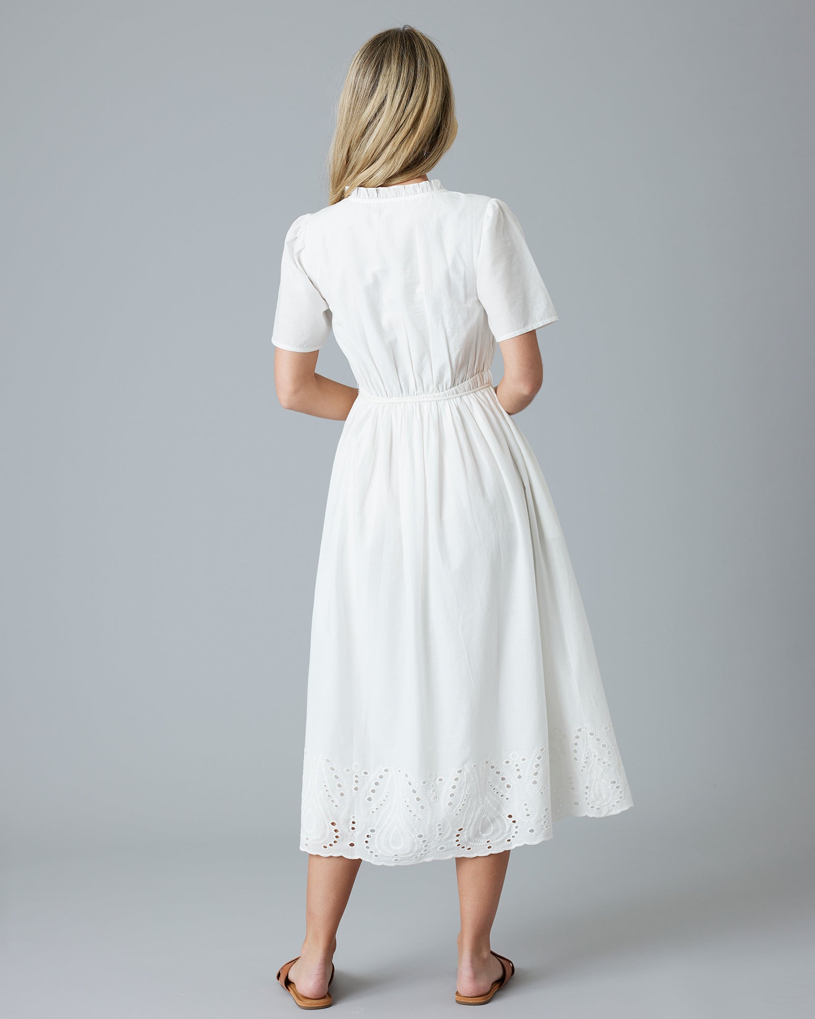 Woman in a white short sleeve midi-length dress