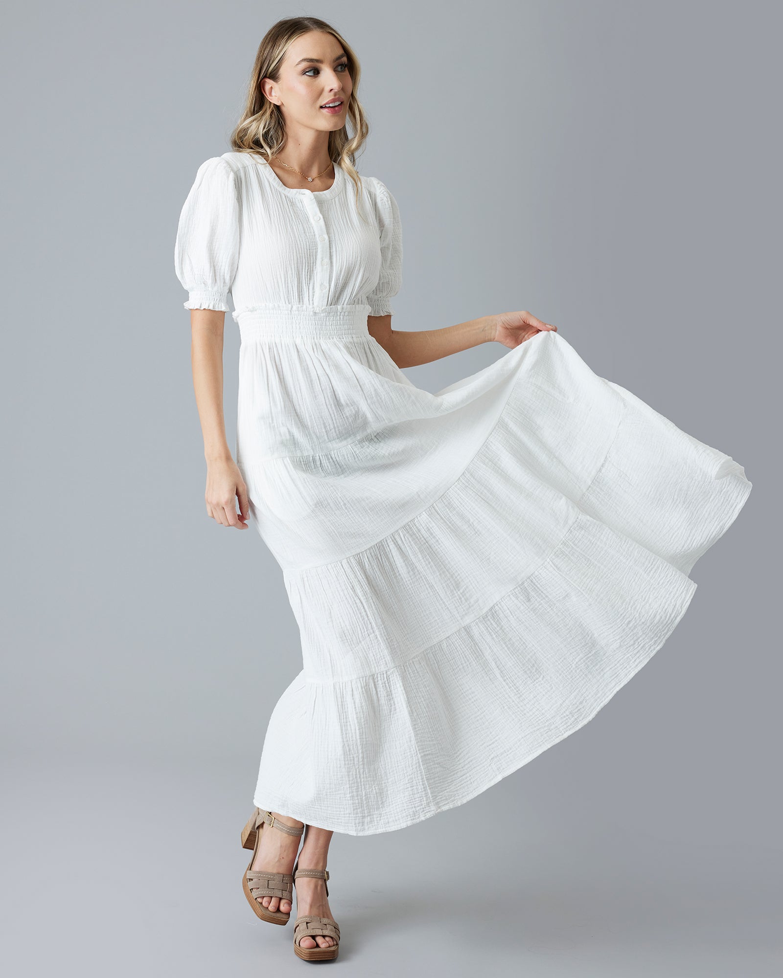 Woman in a white short sleeve maxi-length dress