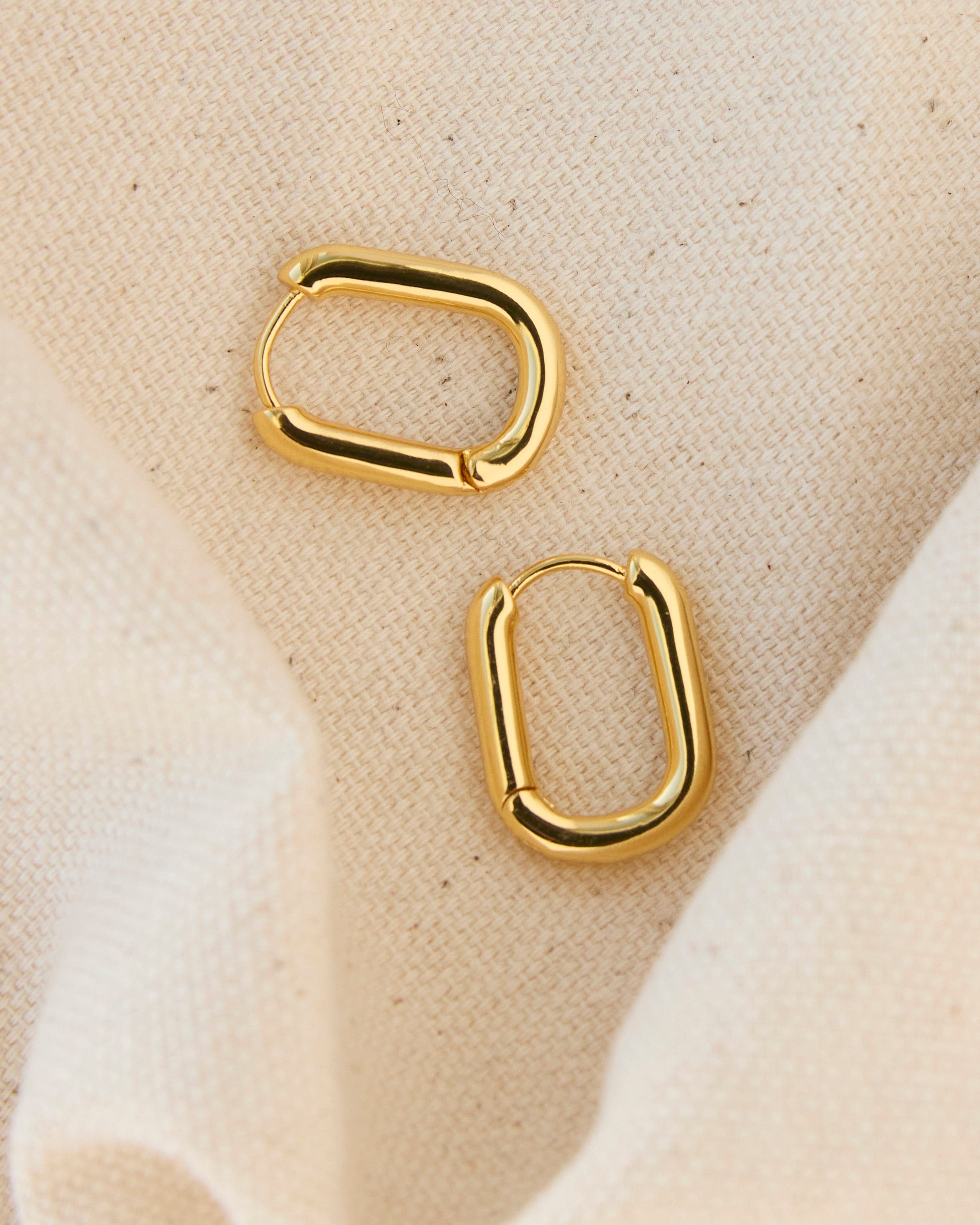 Gold curved hoop earrings.
