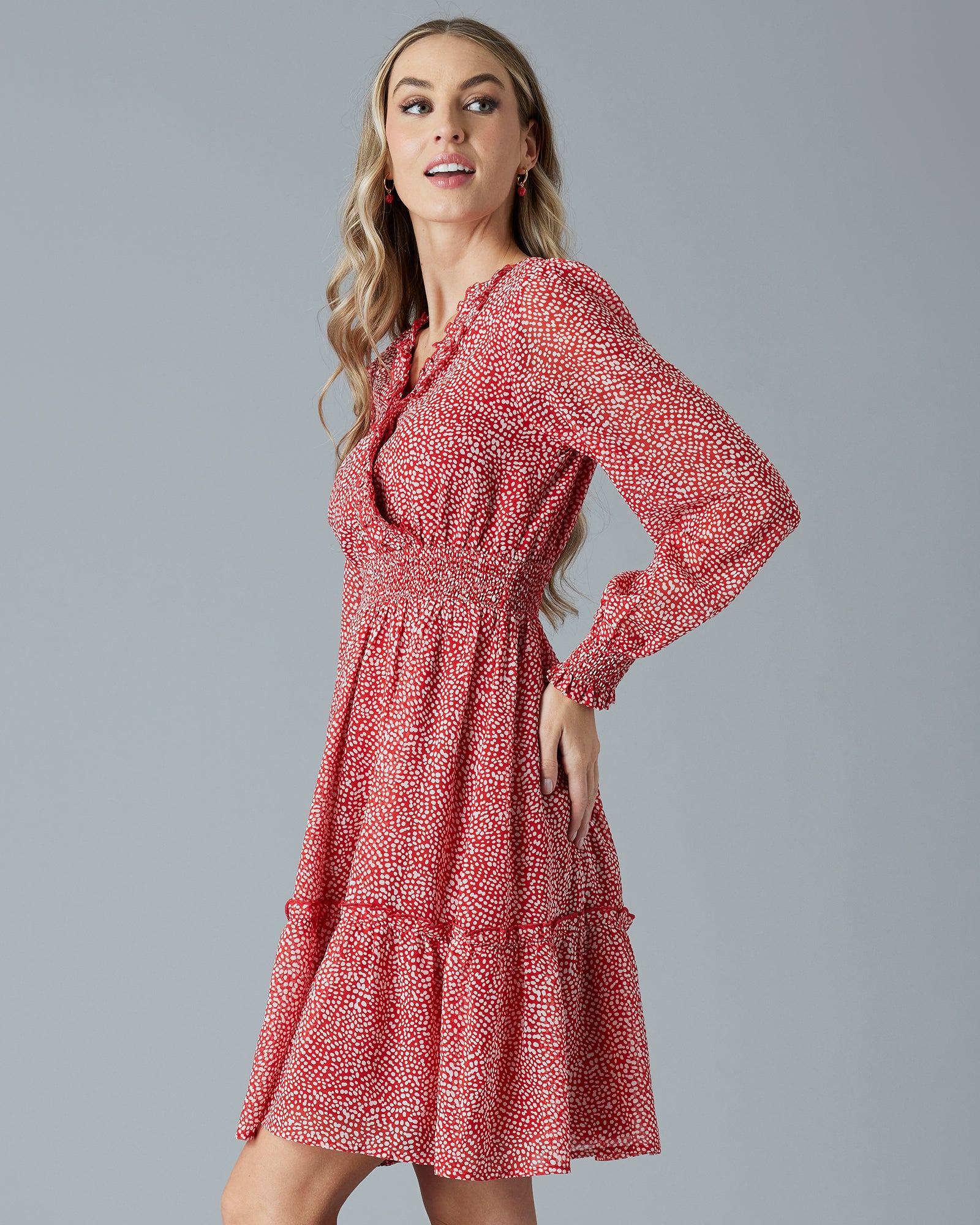 Woman wearing a floral print, long sleeve, knee-length dress.