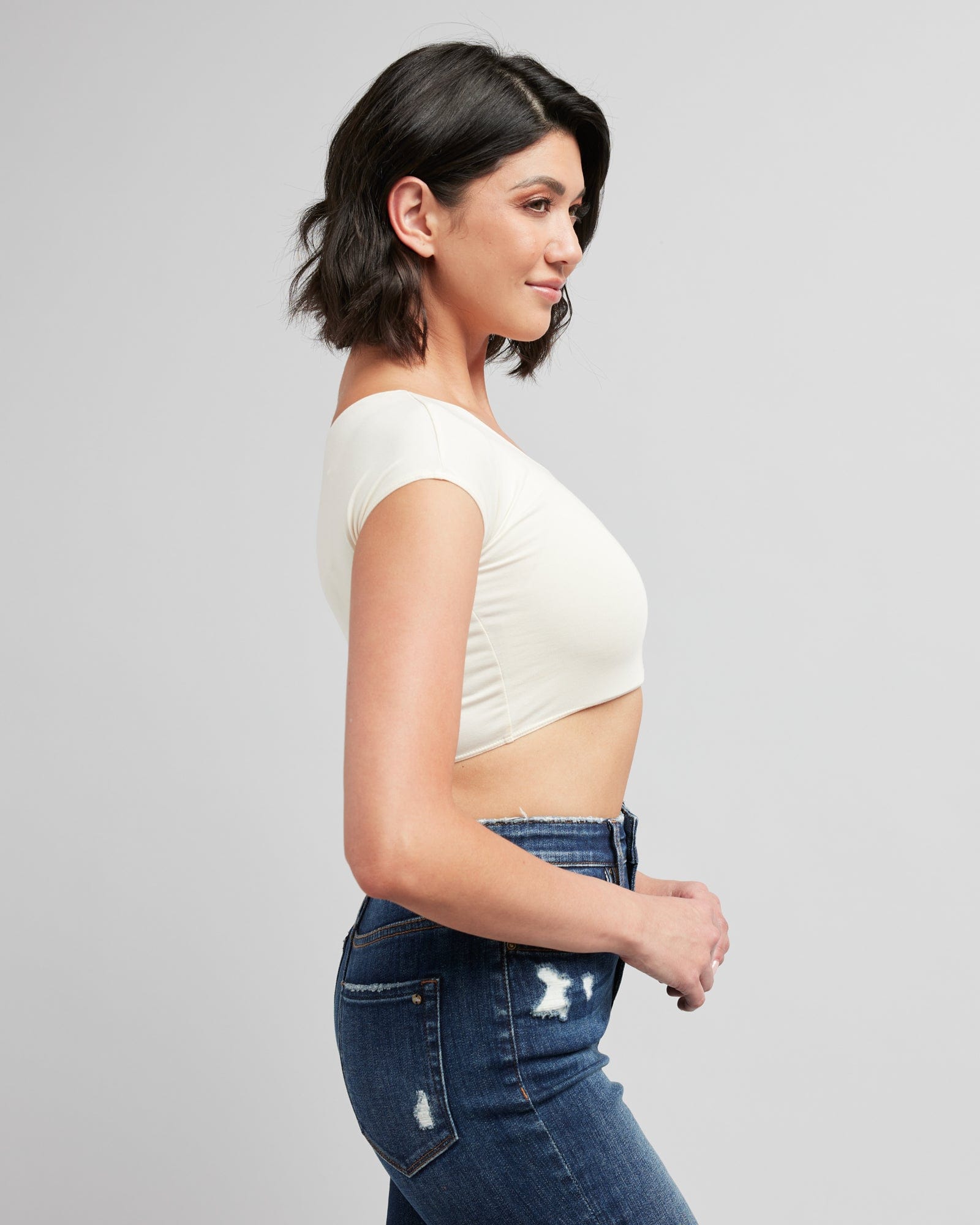 Woman in a cropped, short sleeve, basic tee