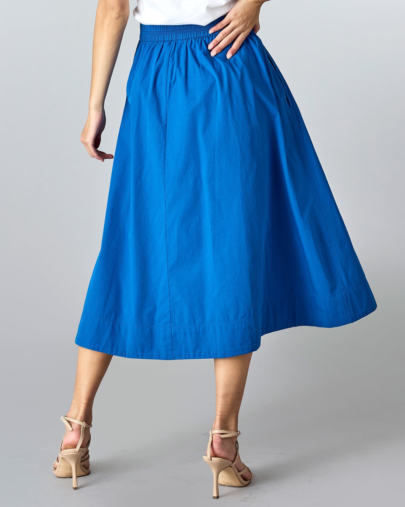 Woman in a blue, midi-length a-line skirt.