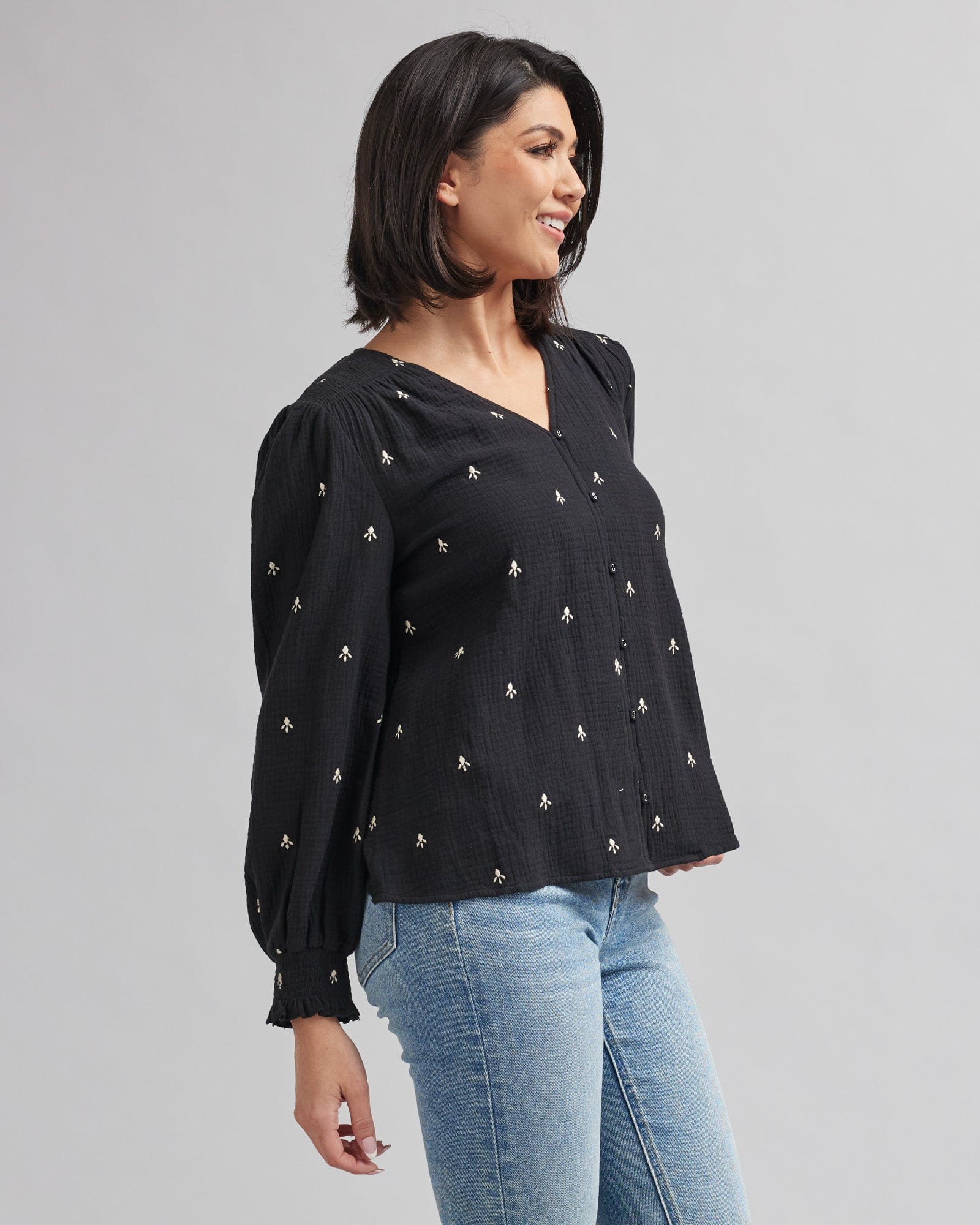 Woman in a long sleeve black with white accent blouse