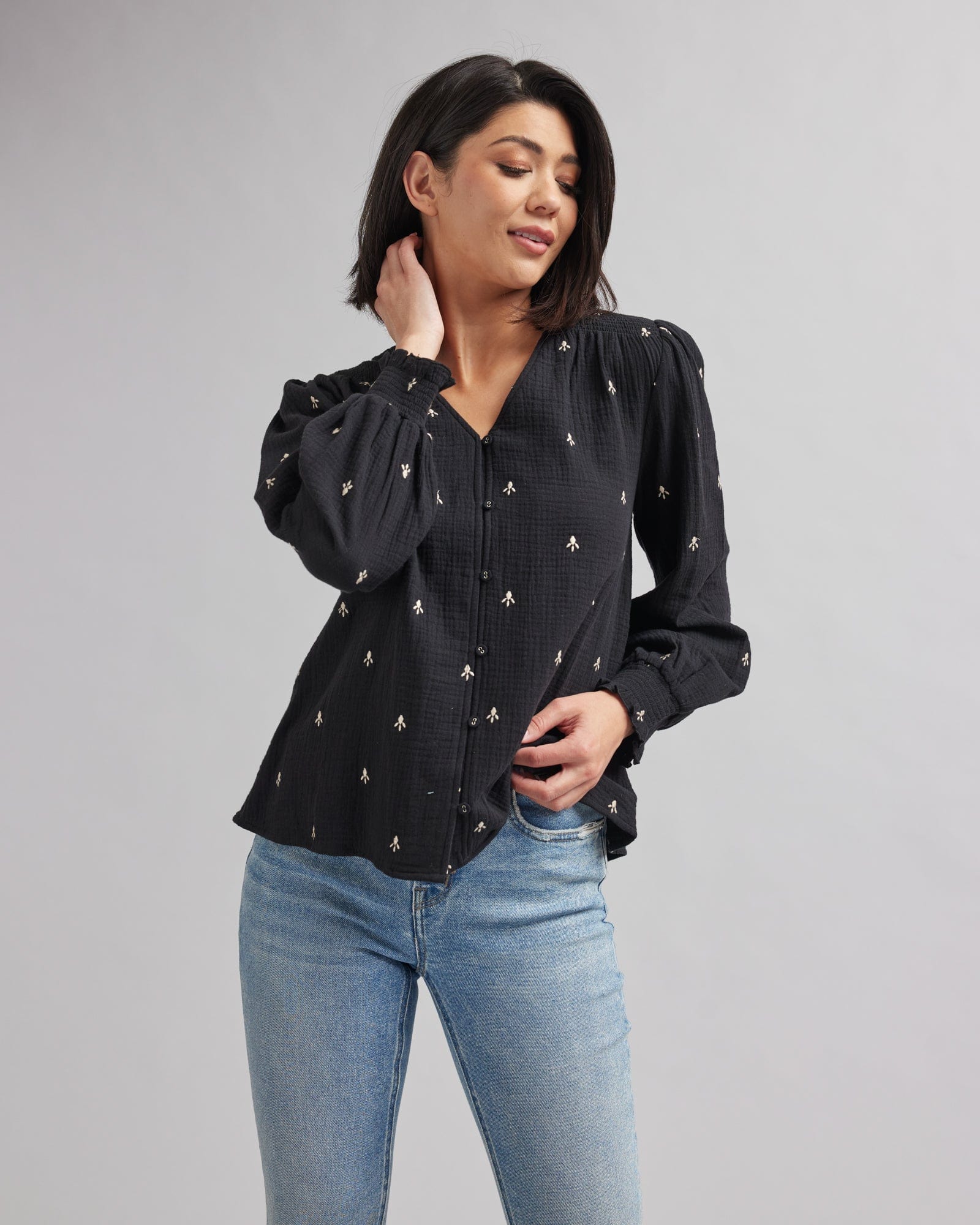 Woman in a long sleeve black with white accent blouse