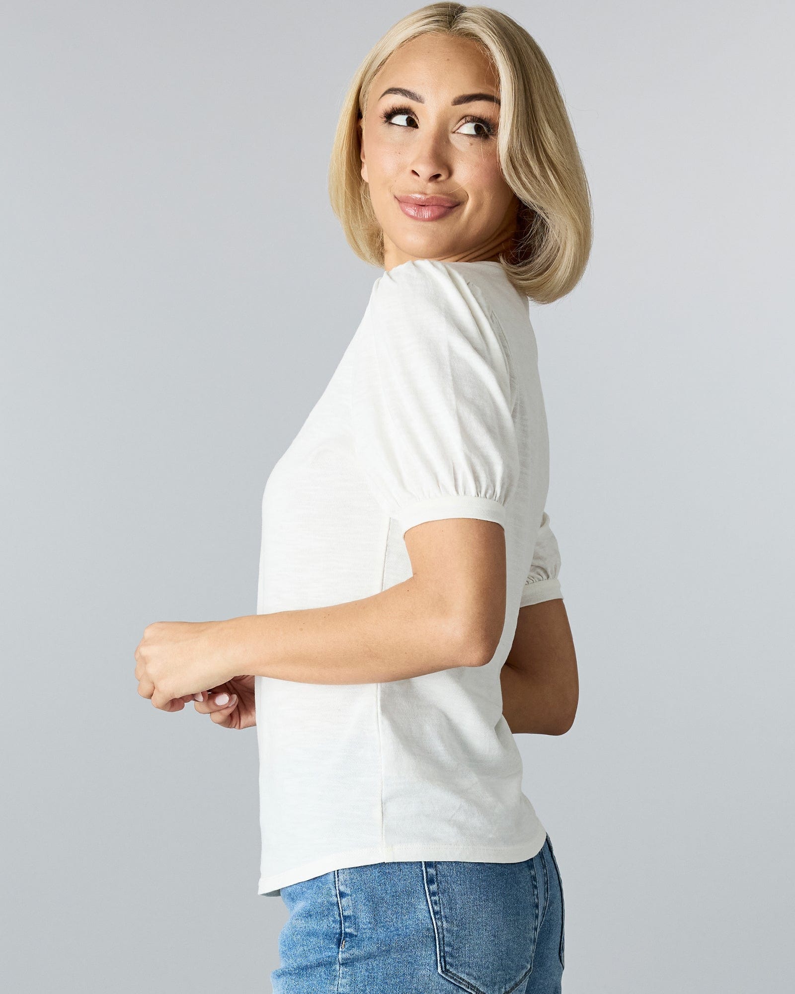 Woman in a short sleeved t-shirt.