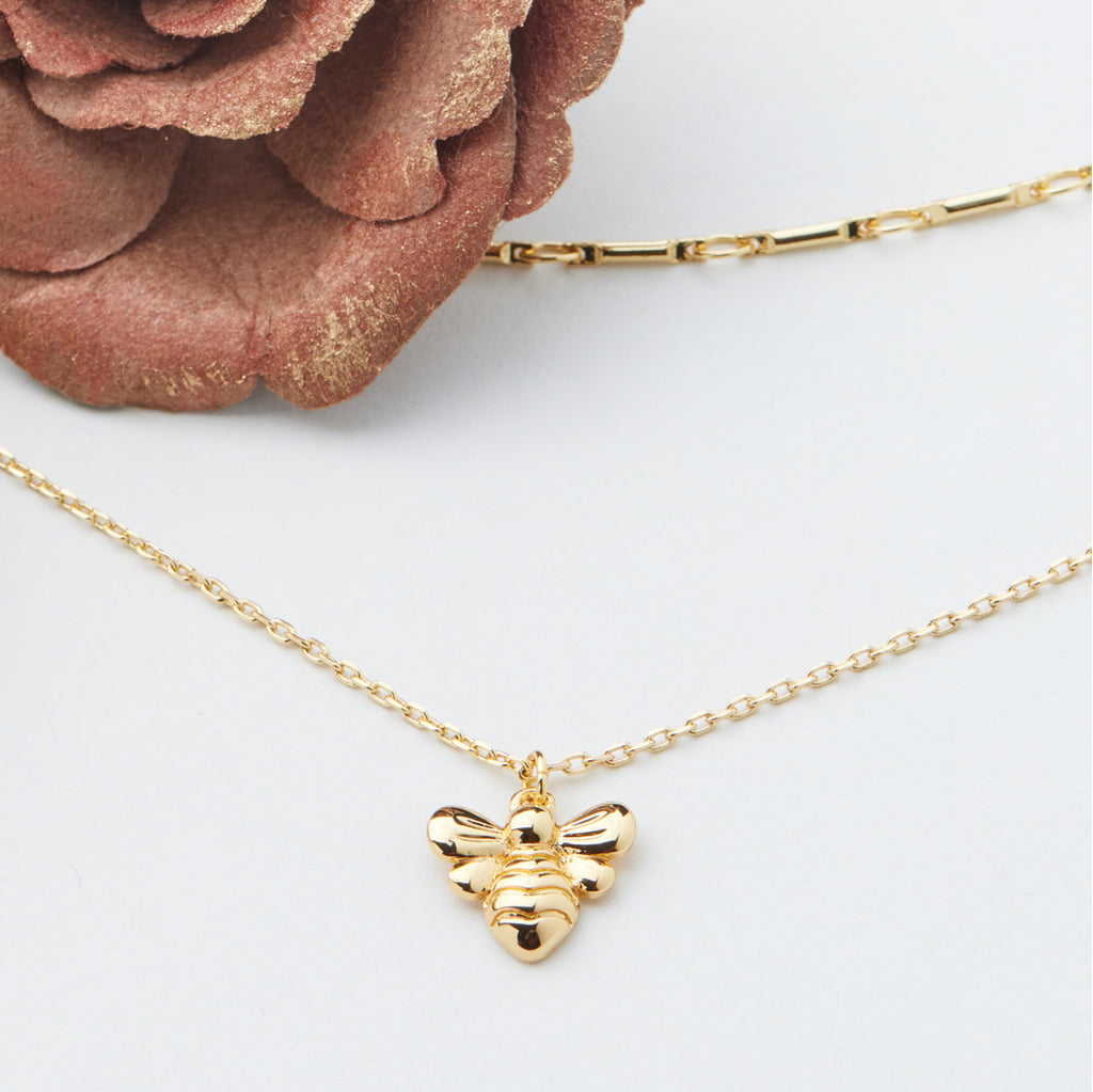 A Layered Necklaces with a bee as the focal point 
