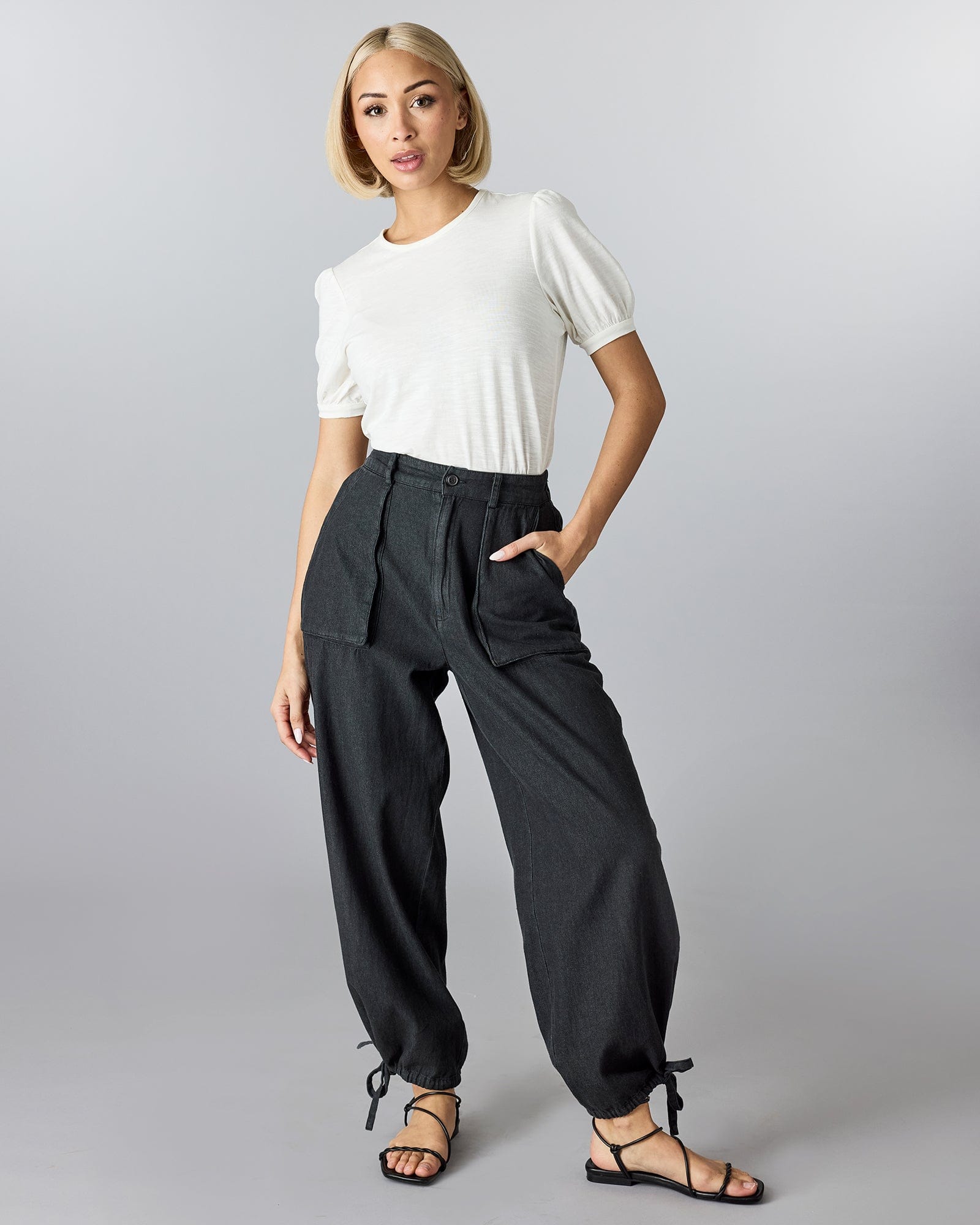 Woman in black pants with front pockets. 