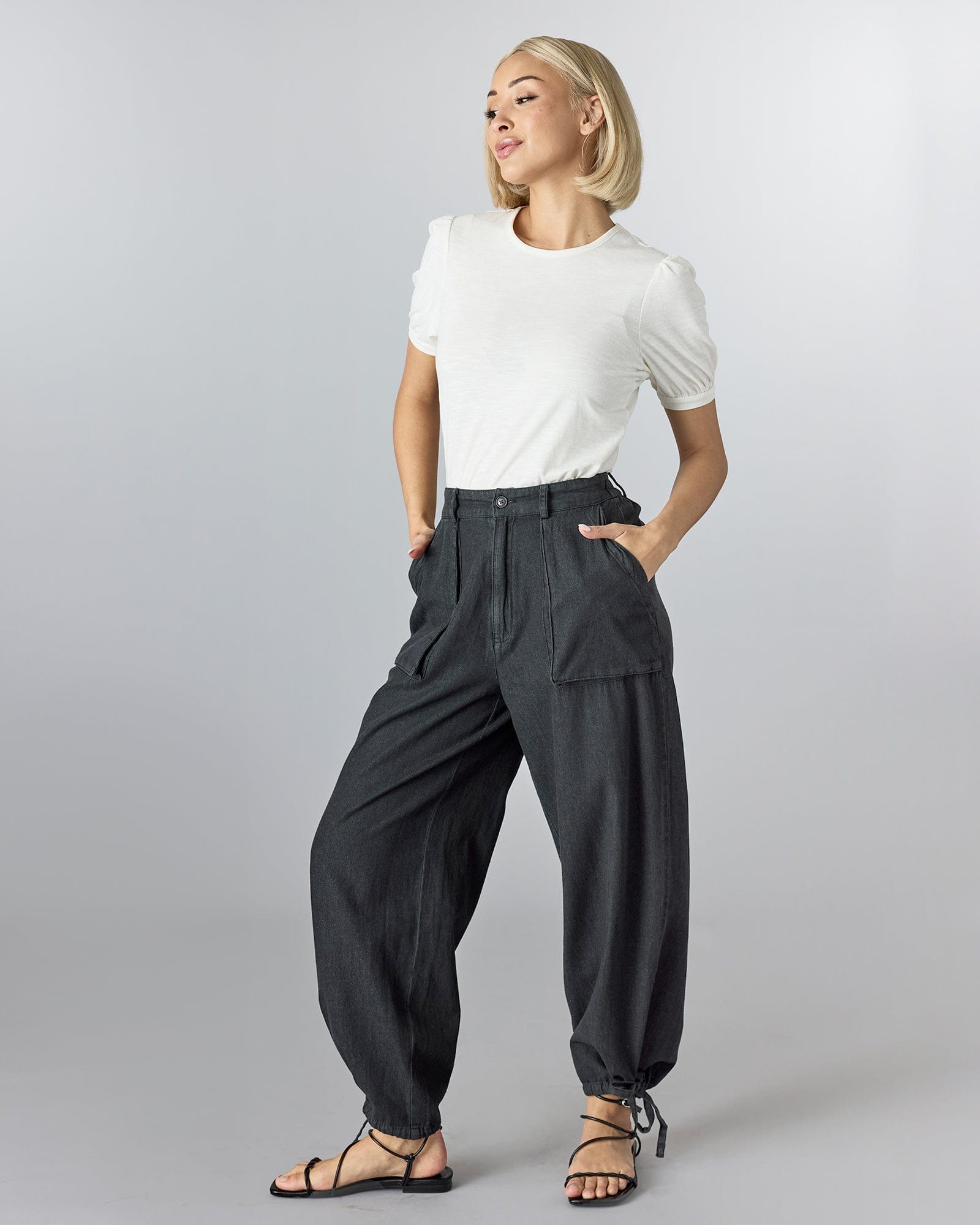 Woman in black pants with front pockets. 