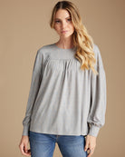 Woman in a gray long sleeve blouse