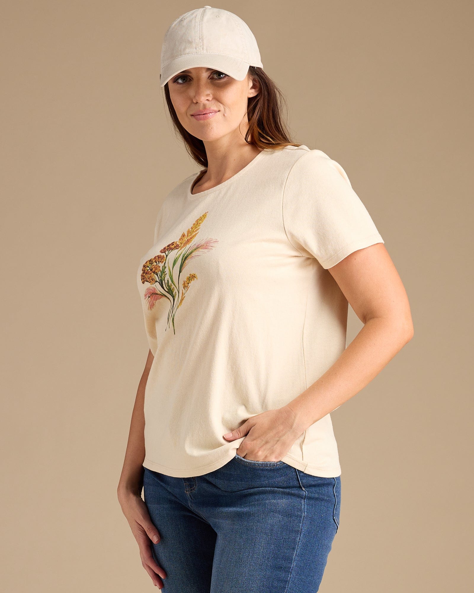 Woman in an off-white graphic tee with a floral print