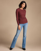 Woman in a maroon long sleeve ribbed top