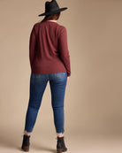 Woman in a maroon long sleeve ribbed top