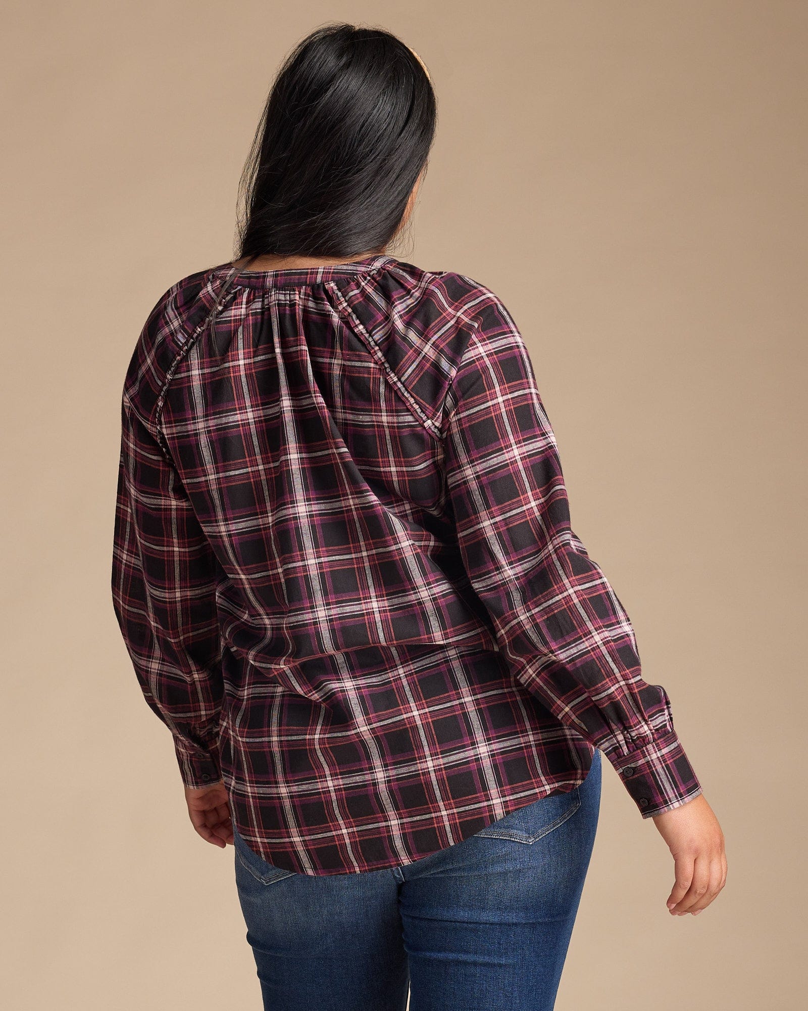 Woman in a blue plaid long sleeve top