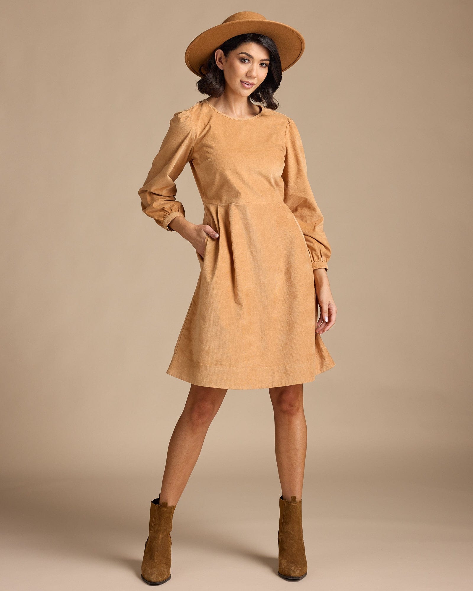 Woman in a long sleeve, knee-length, yellow dress