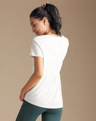 Woman in a white tee with asymmetrical hem
