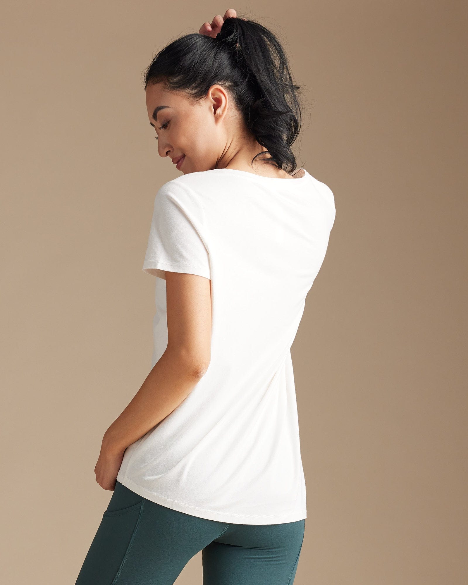 Woman in a white tee with asymmetrical hem