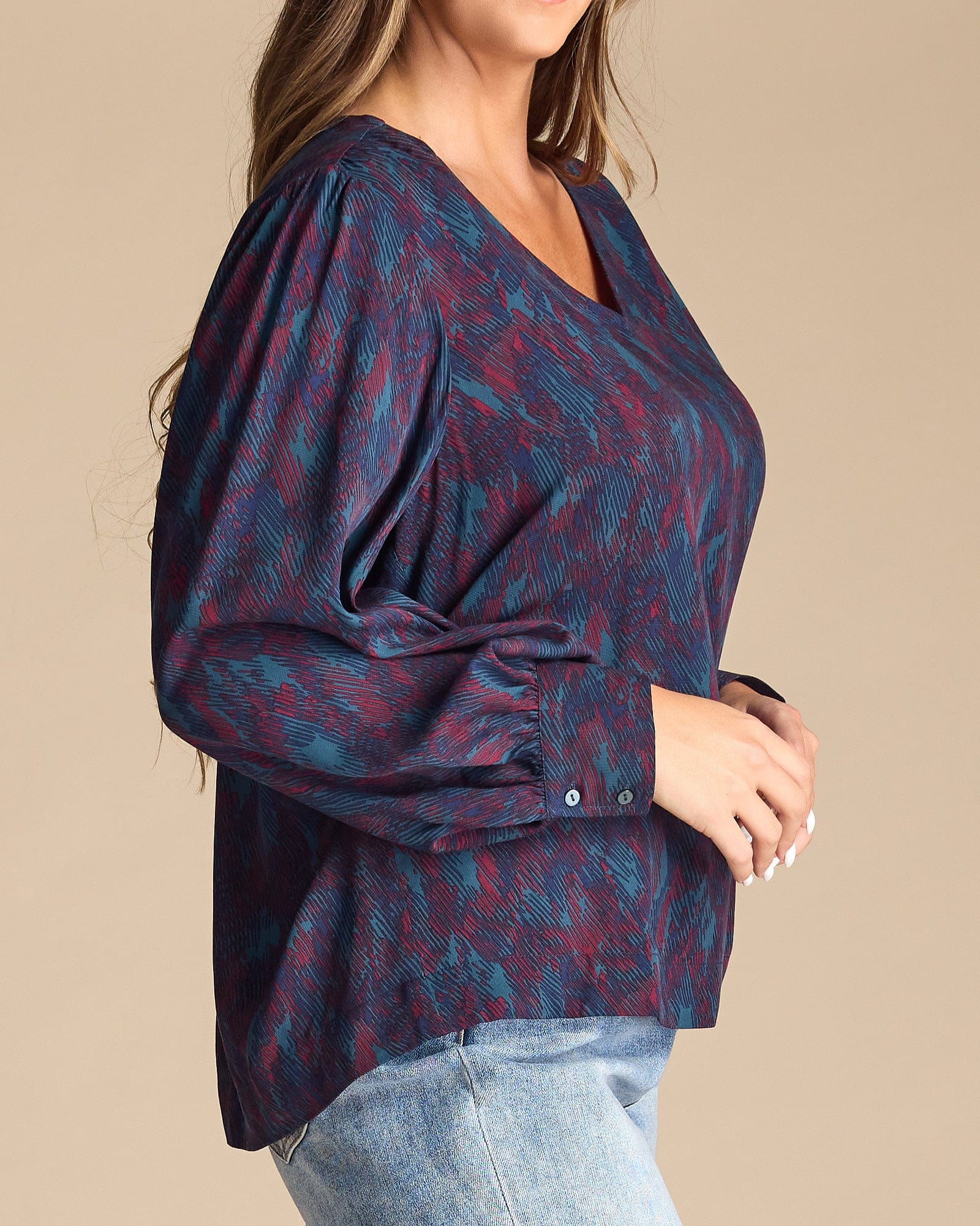 Woman in a blue and purple printed long sleeve blouse