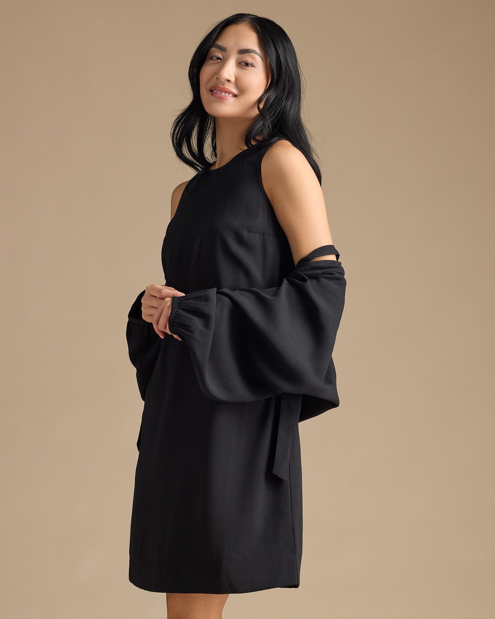 Woman in a black dress with removable sleeves