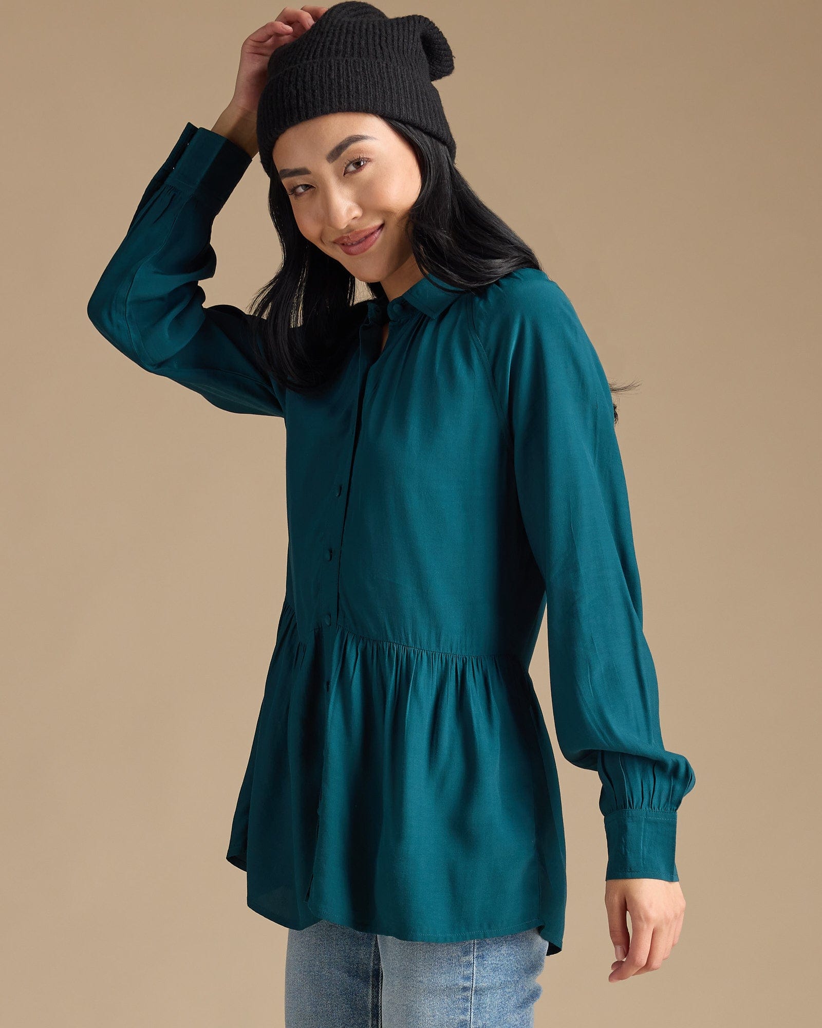 Woman in a teal button-down peplum top