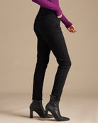 Woman in black high-rise skinny cropped jeans