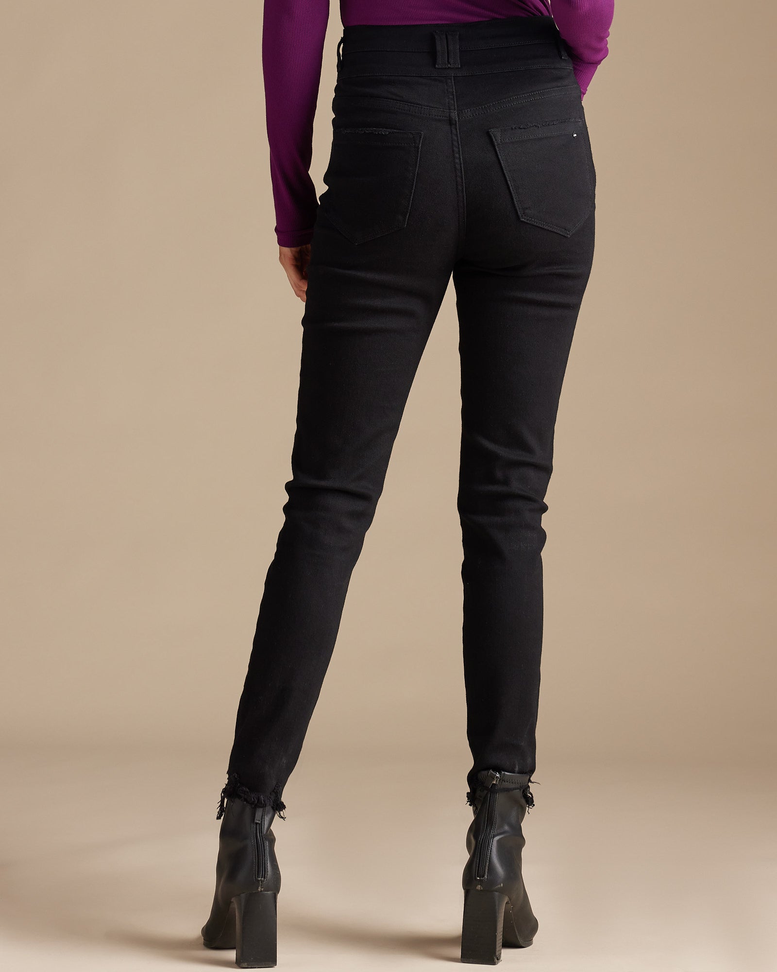 Woman in black high-rise skinny cropped jeans