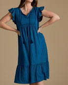 Woman in a short sleeve, midi-length, v-neck, blue dress