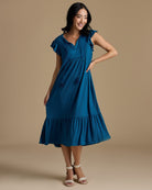 Woman in a short sleeve, midi-length, v-neck, blue dress