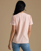 Woman in a light pink short sleeve tshirt