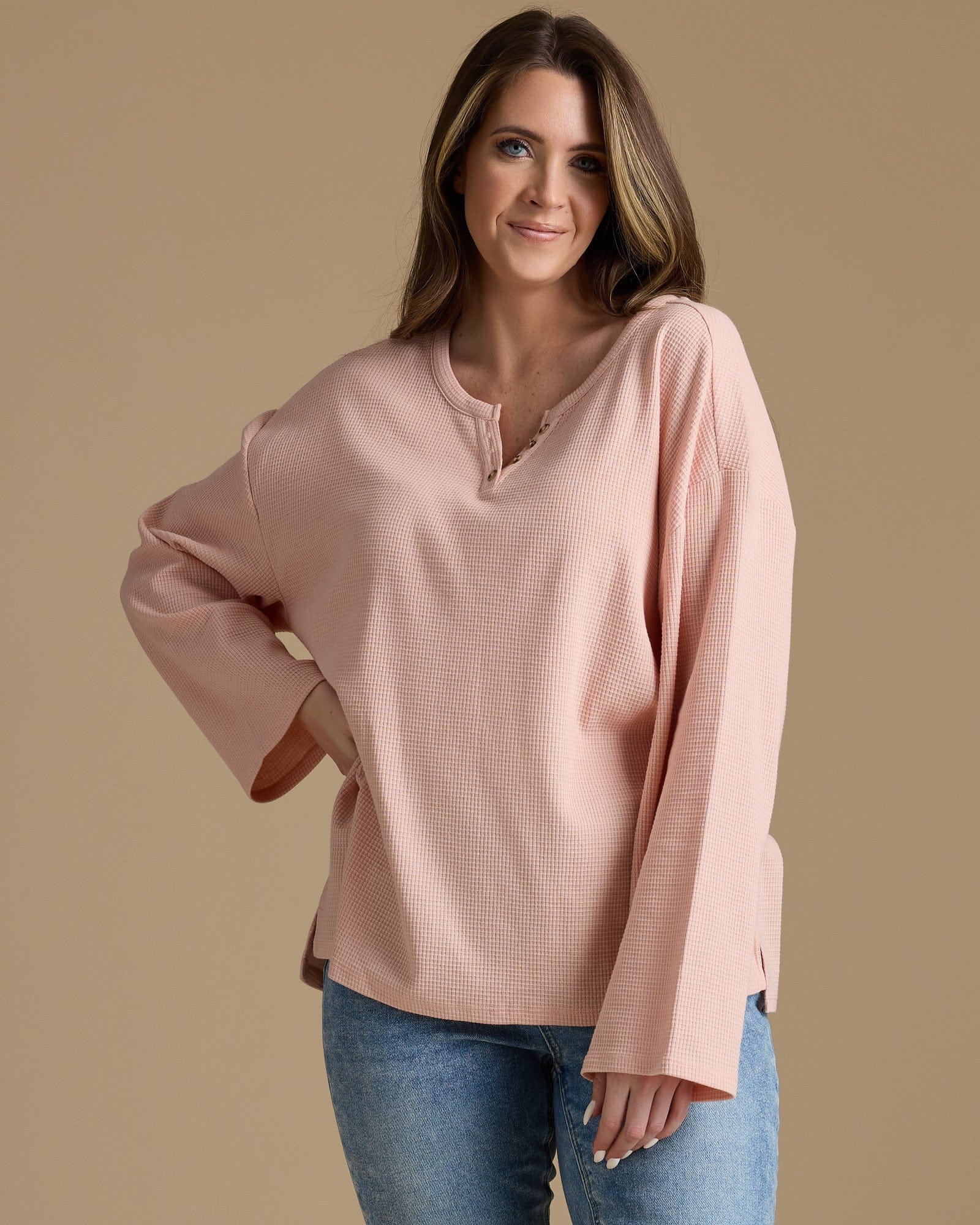 Woman in a pink, ribbed long sleeve shirt