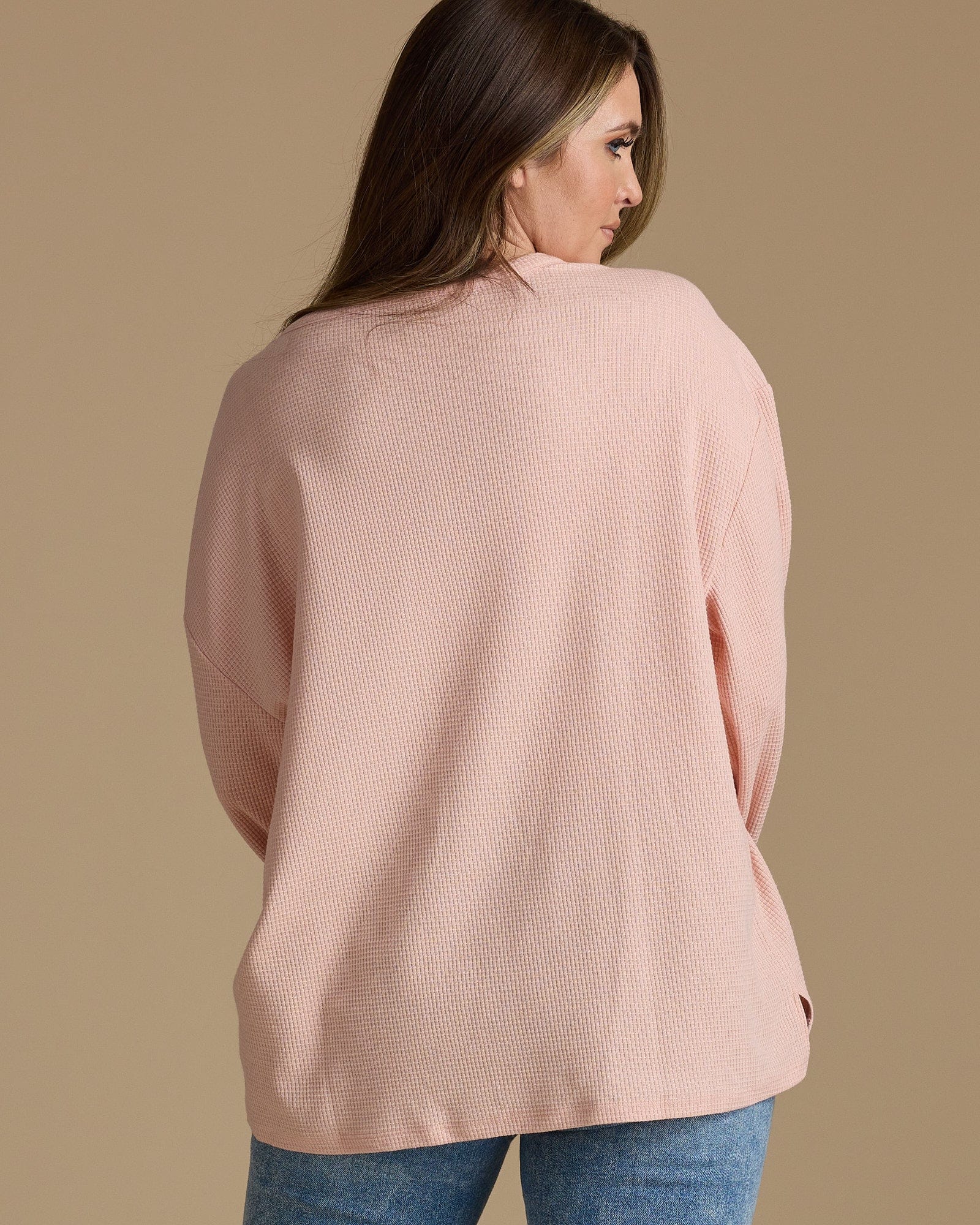 Woman in a pink, ribbed long sleeve shirt