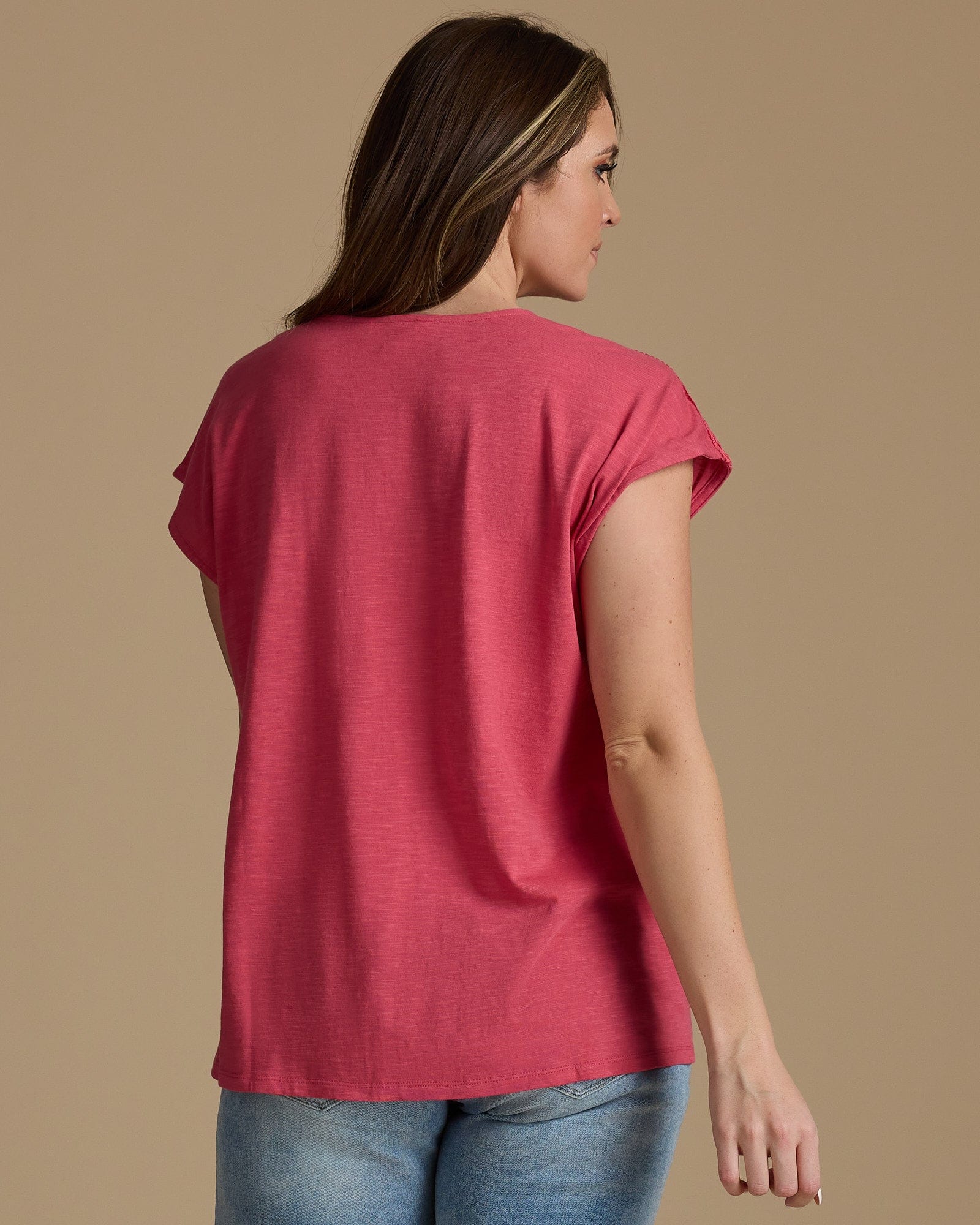 Woman in a pink v-neck top